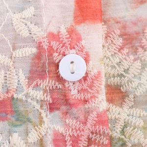 Floral print pink tulle shirt with intricate white embroidery and button detail