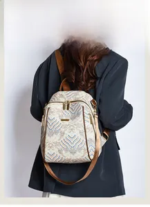 Detail of New Chinese style backpack showing traditional wave patterns and gold hardware