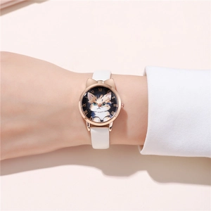 Close-up of cat ear rose gold watch case with floral feline dial and white leather strap