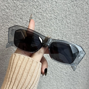 Detail of modern translucent smoke grey rectangle frame sunglasses with dark lenses