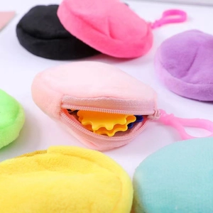 Detailed macro view of colorful mini plush coin purses with zippers and hanging hooks