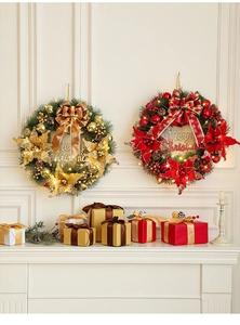 Detail of Christmas wreath with LED lights, bows and ornaments on a white fireplace