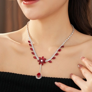 Exquisite silver necklace with red floral zircon pendant shown on model neck