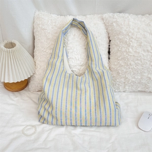 Detail of blue and yellow striped hobo bag made of lightweight textured canvas material