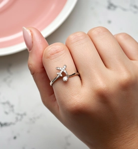 Macro detail of S925 sterling silver airplane ring with tiny diamonds on a model hand
