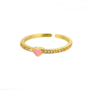 Macro detail of golden open ring featuring a pink heart center and sparkling zircon accents