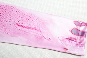 Close-up of pink and white abstract print cuff with high-quality stitching detail