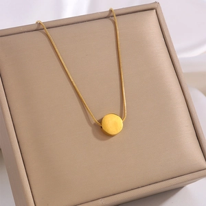 Minimalist 18k gold-plated stainless steel necklace with round pendant on display