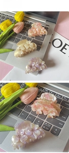 Detail of floral acetate shark hair clips with pearl gradient finish and crystal accents