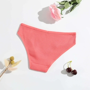 Detail of coral pink ribbed cotton panties with elegant floral and cherry background