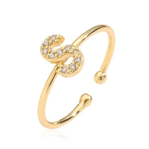 Close-up of gold plated open ring with crystal-encrusted letter S detail