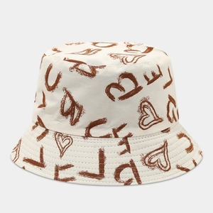Close-up of hand-drawn heart graffiti and love print on beige cotton bucket hat