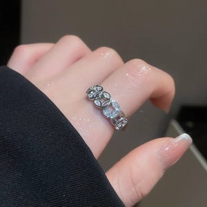 Detailed view of silver chain ring with interlocking oval units and pavé-set zircons