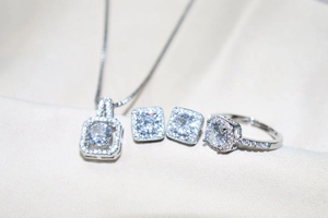 Detailed set of silver zircon necklace, earrings and ring with square cushion-cut stones