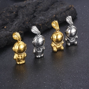 Detailed row of gold and silver astronaut pendants on a professional black stone surface