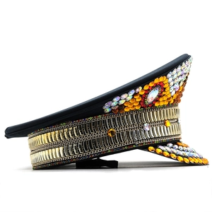 Detail showing the intricate gold chains and colorful rhinestones on a captain hat