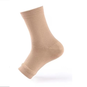 Beige compression ankle sleeve with ribbed knit fabric for sports support on white background