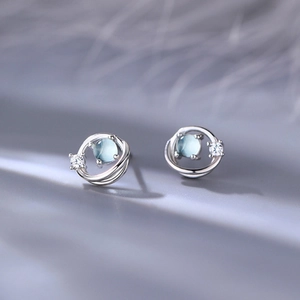 Cosmos Saturn stud earrings with blue glass and star design in minimalist silver finish