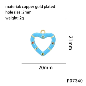 Close-up of heart-shaped gold-plated pendant with blue enamel and colorful cubic zirconia