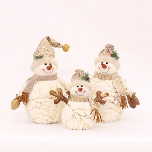 Three plush snowman figurines with gold leaf patterns and festive hats for Christmas decor