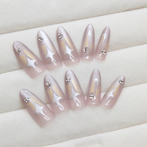 Cat eye press-on nails with silver star patterns and rhinestones on pink gradient base
