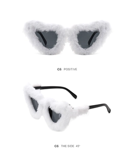 Close-up views of plush heart-shaped sunglasses in white fur with dark grey lenses