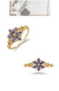 Detail of 14K gold plated ring with marquise-cut violet stones in floral design