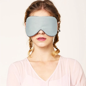 Front view of gray cotton sleep eye mask on model for light blocking and comfort