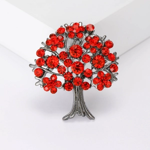 Exquisite tree of life brooch in dark metal featuring vibrant red rhinestones on white