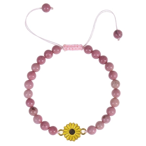 Detailed shot of 6mm pink mahogany stone beads with a yellow sunflower charm and gold trim
