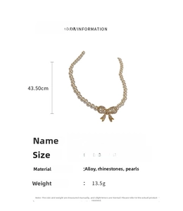 Detail view of pearl bowknot necklace showing adjustable size from 36.5cm up to 43.5cm