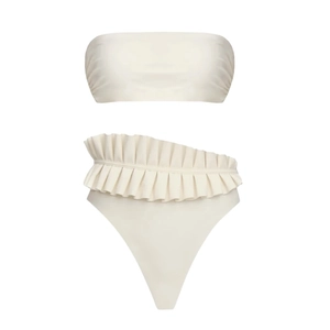 Detail view of cream high-waisted bikini bottoms featuring dramatic ruffled waist design
