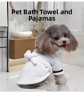 Detail of soft white flannel pet bathrobe with black trim shown on a small dog