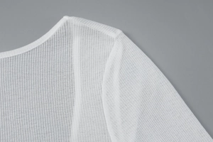 Dettaglio del tessuto in maglia a coste bianche con texture fine e trama traspirante