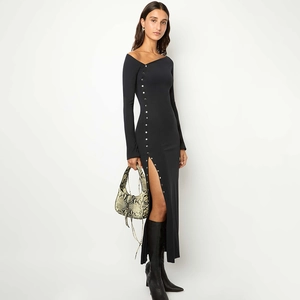 Detail of black side-slit dress with elegant silver buttons and high-cut leg design