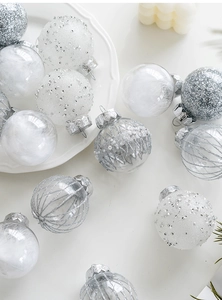 Detail of elegant silver and white Christmas ornaments with glitter and feathers