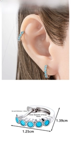 Detail view of silver huggie earrings with five sky blue stones and size measurements