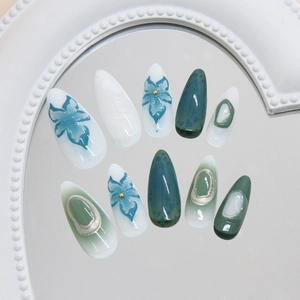 Green lily press-on nails with irregular polka dots and floral relief patterns
