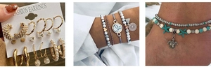 Detail of beach anklets featuring silver turtles and turquoise starfish charms