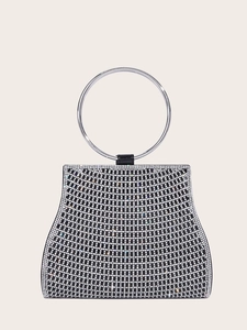 Detail showing white rhinestones and large silver metal ring handle on an evening bag