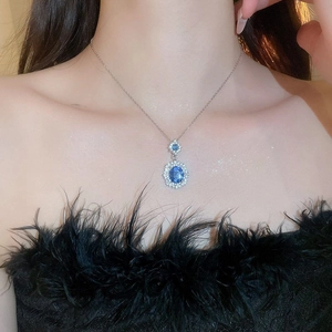 Vintage style oval blue gemstone necklace with diamond accents on silver chain