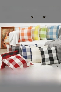 Close-up of minimalist cotton linen plaid cushion covers with hidden zippers on a sofa