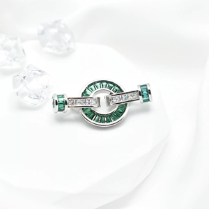 Interlocking silver jewelry clasp with baguette emerald and white cubic zirconia
