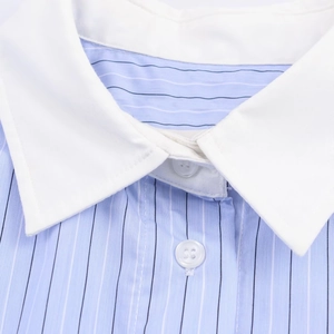 Macro detail of blue pinstripe shirt featuring a contrast white collar and clear buttons