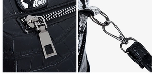 Detail of crocodile-embossed leather texture with silver zipper and snake-pattern trim