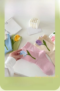 Close-up of pastel combed cotton socks featuring delicate tulip flower embroidery details
