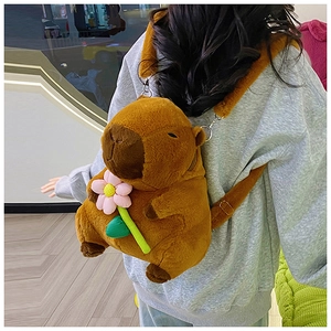 Detailed back view of a plush Capybara backpack with pink flower accessory on model