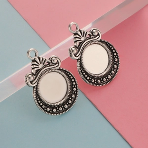 Detailed view of silver antique scale moon pendant trays for DIY jewelry making