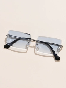 Flat lay of rimless rectangle sunglasses with light blue lenses and silver metal frame
