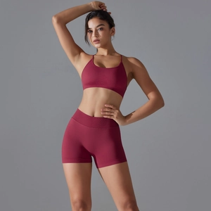 Close-up of seamless dark red knitted sports bra and high-waisted yoga shorts set